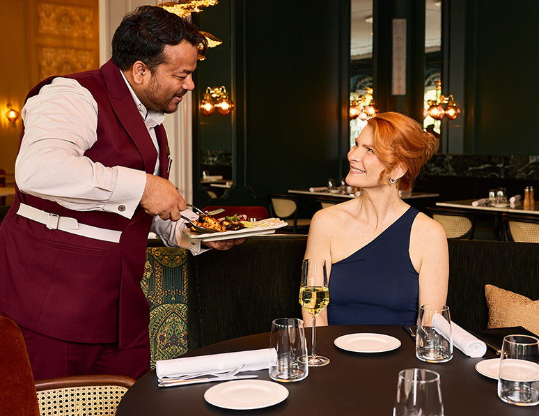 a man serving food to a woman