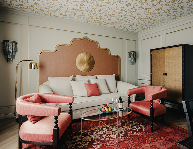 a room with a couch and chairs