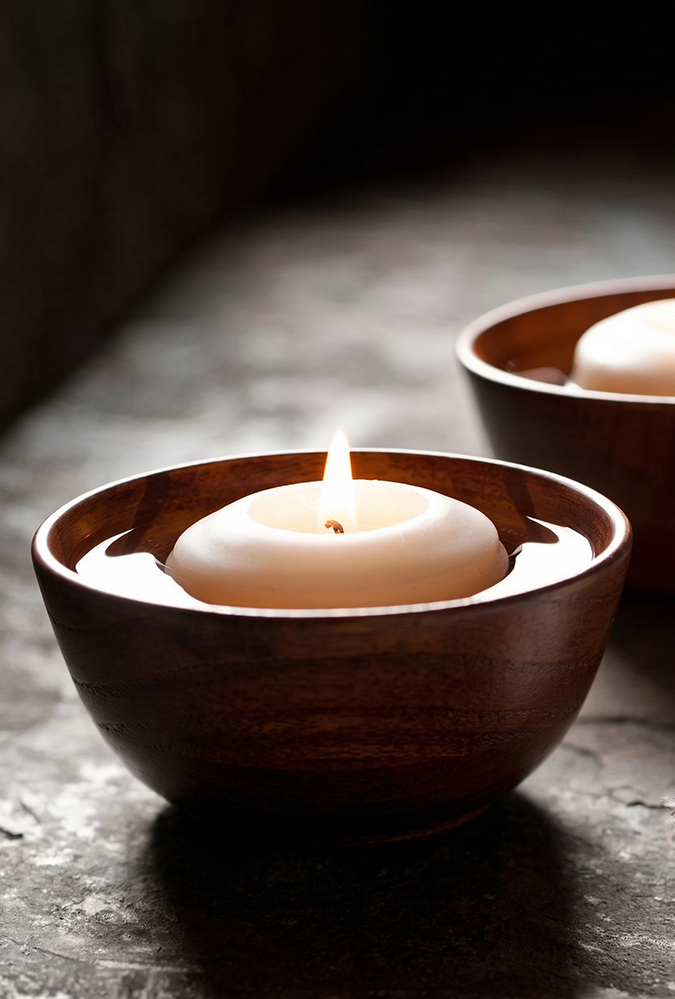 a two candles in a bowl