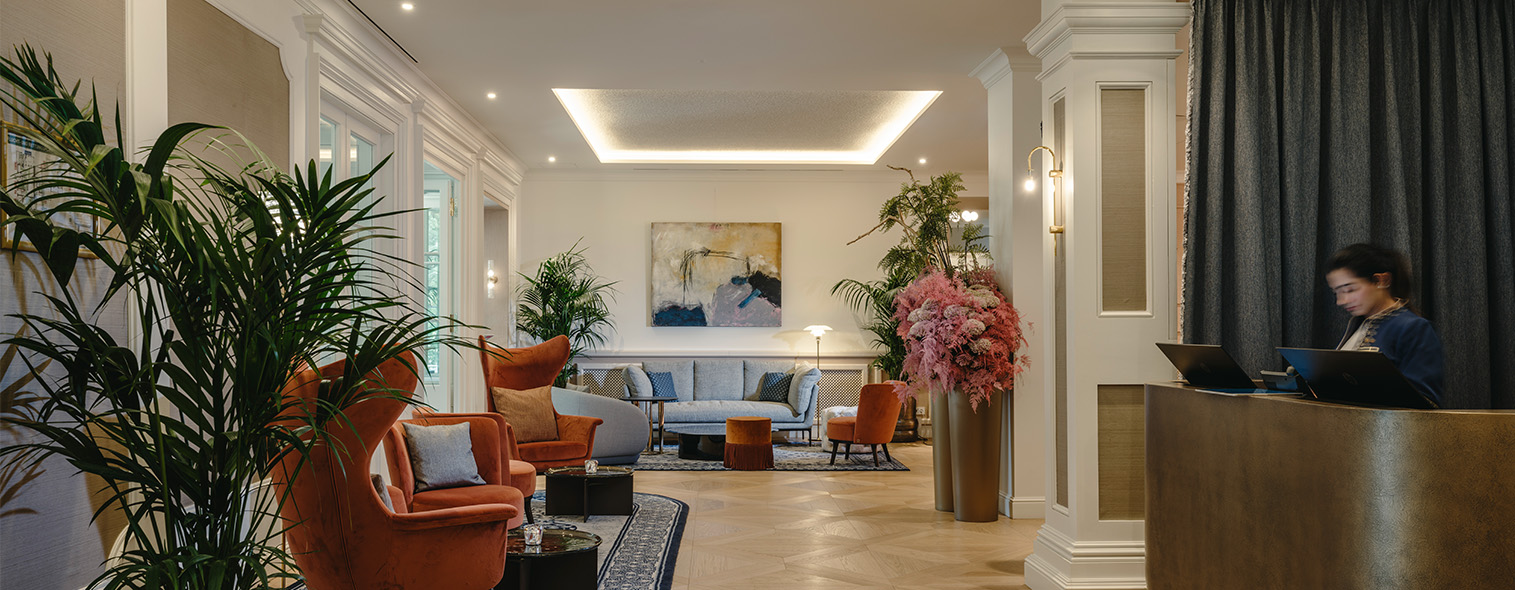 a living room with couches and plants