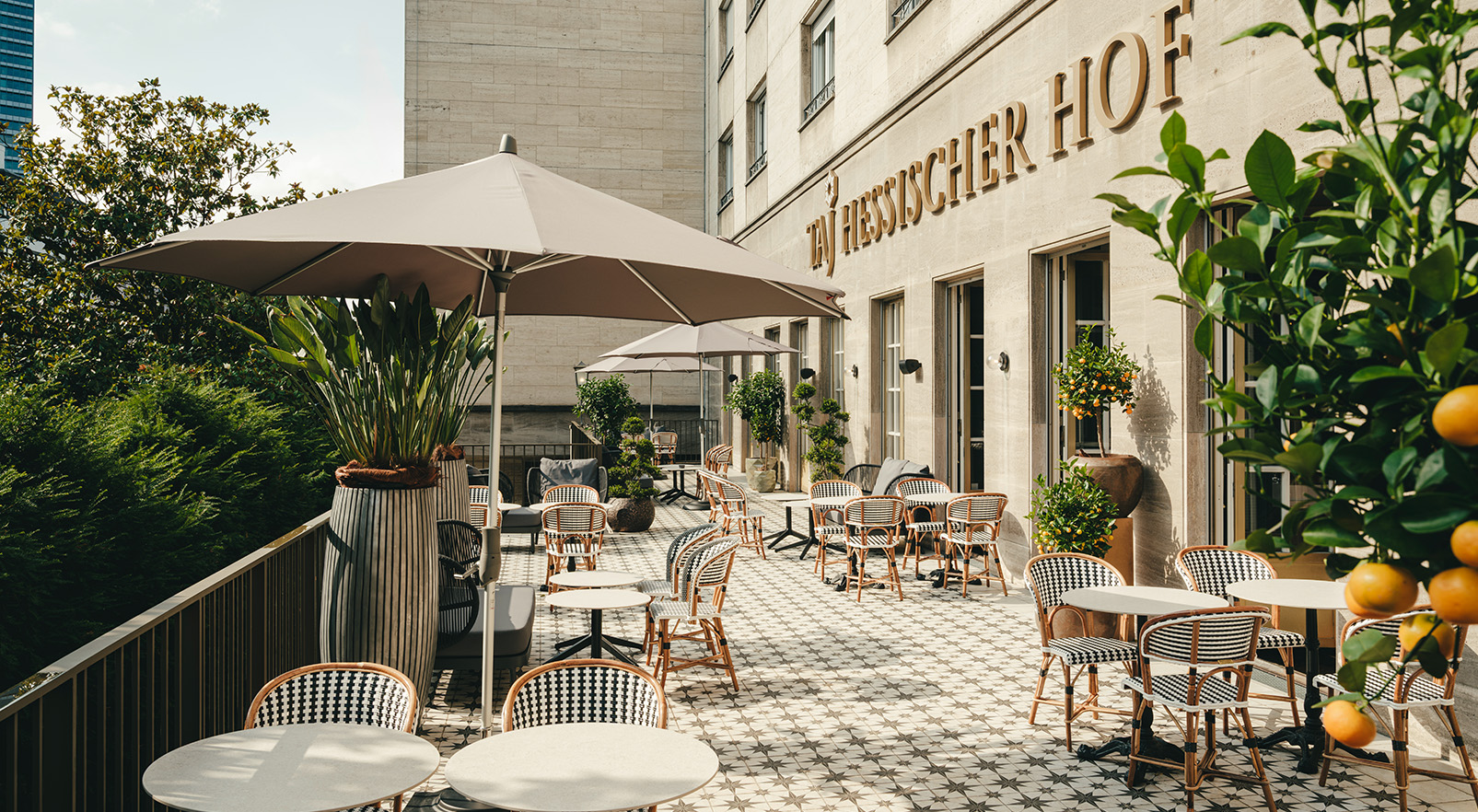 a patio with tables and chairs and umbrellas