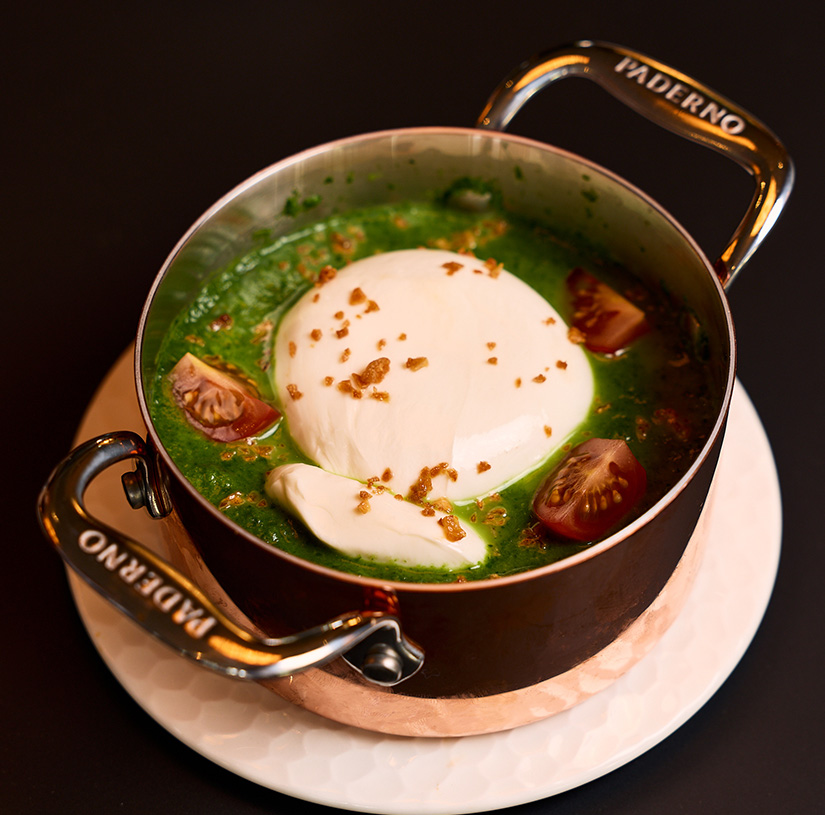 a pot of soup with a white ball in it