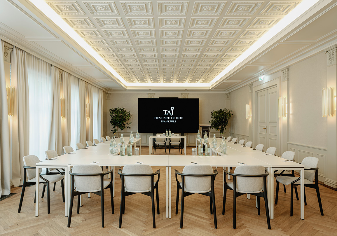 a room with a large table and chairs
