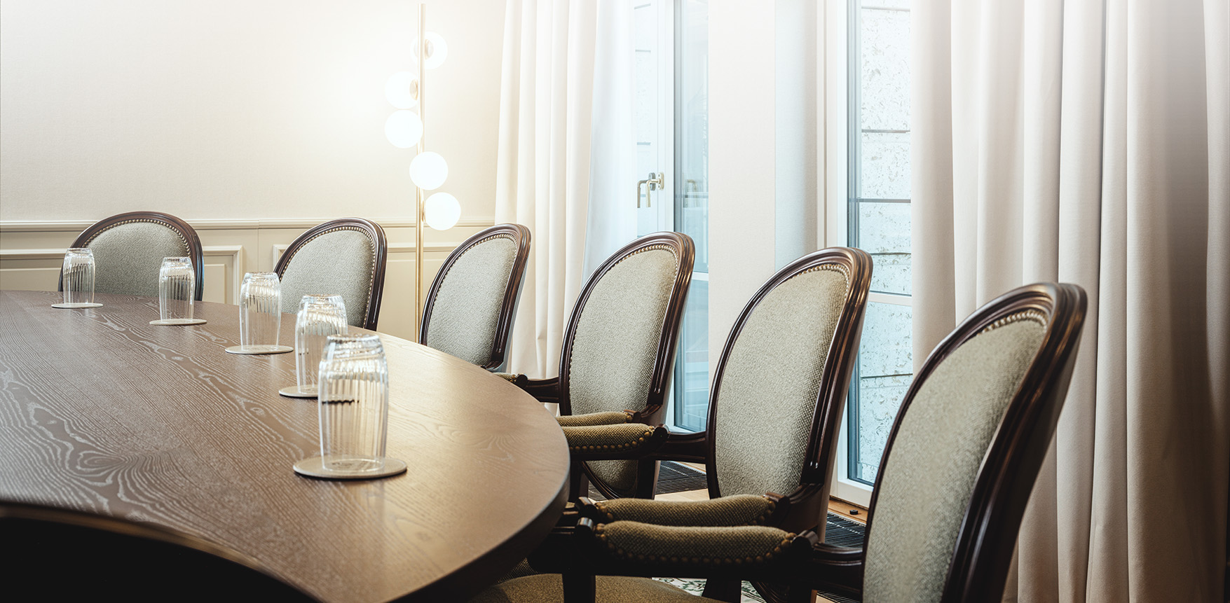 a table with chairs and a lamp in front of it