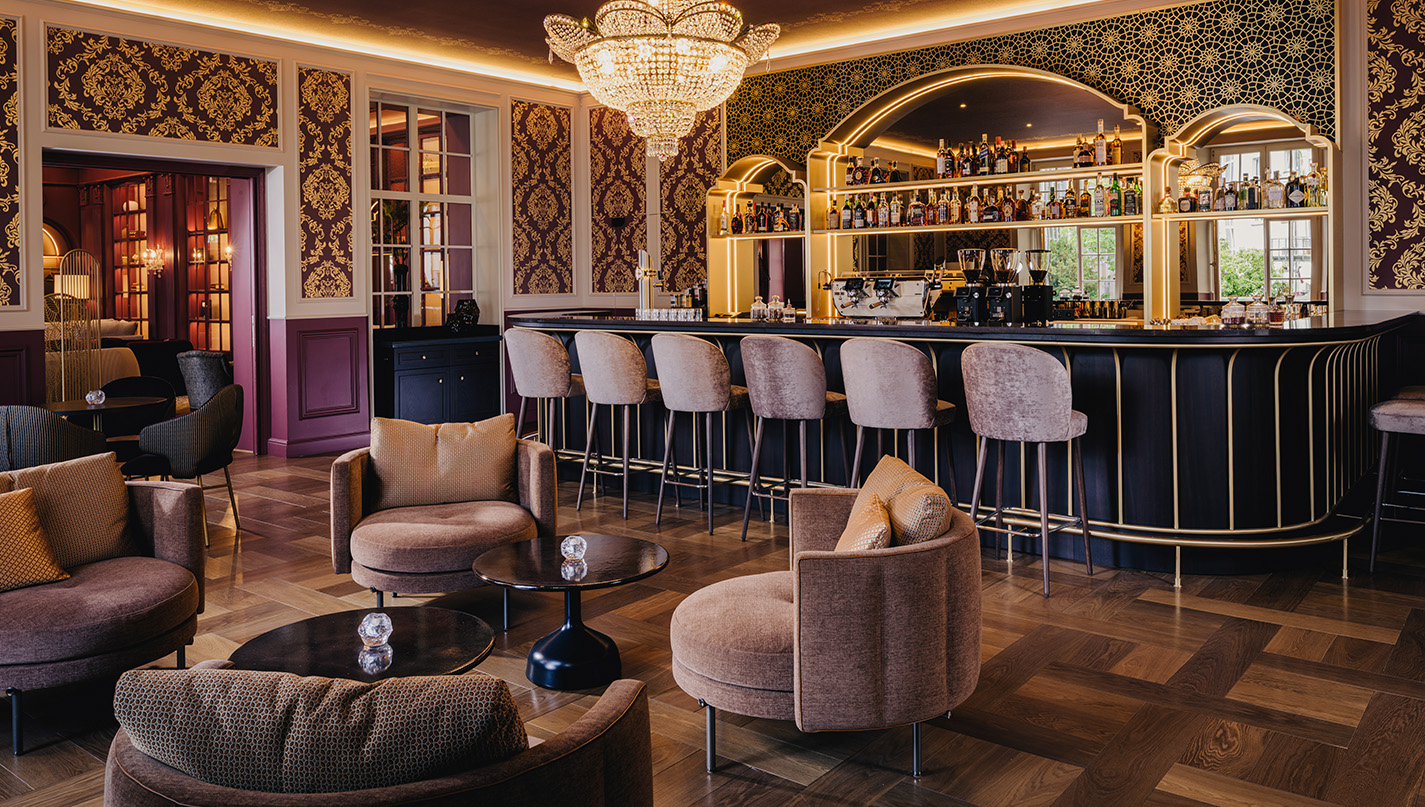 a bar with chairs and a chandelier