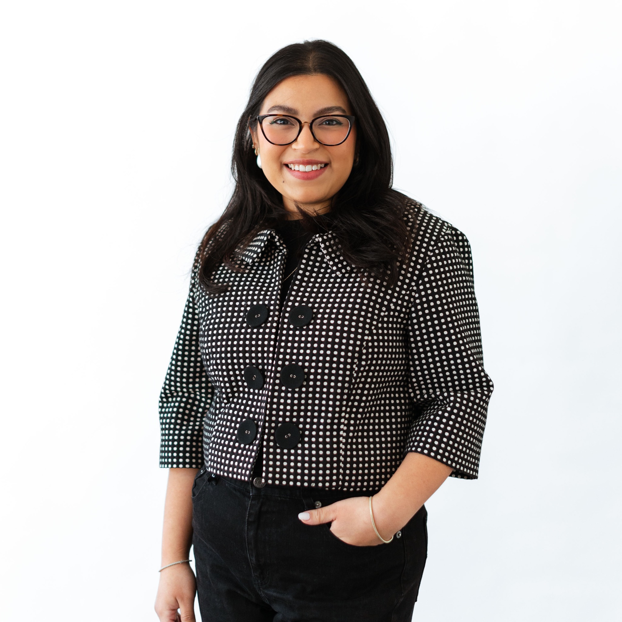 a woman wearing glasses and a black and white shirt