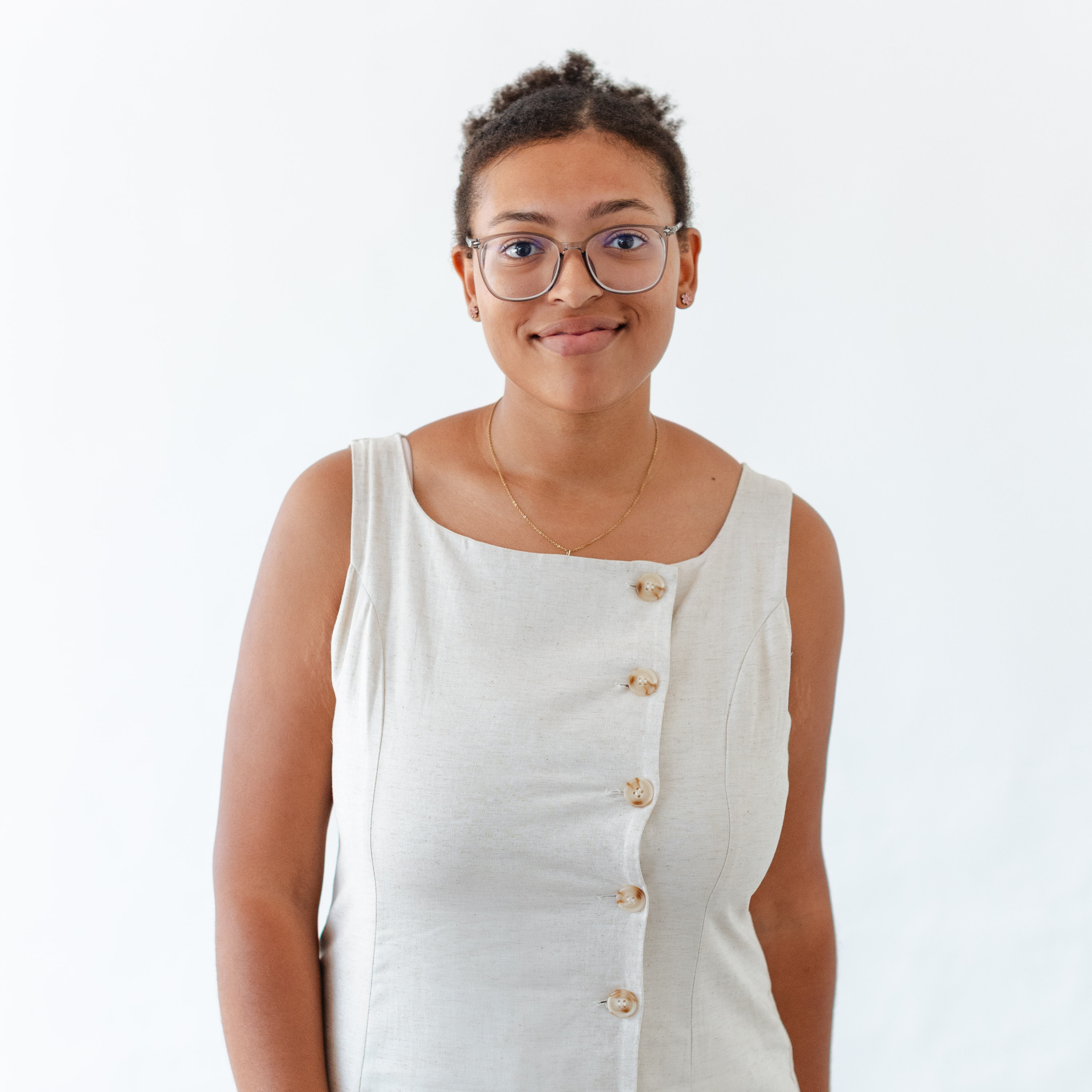 a woman wearing glasses and a white dress