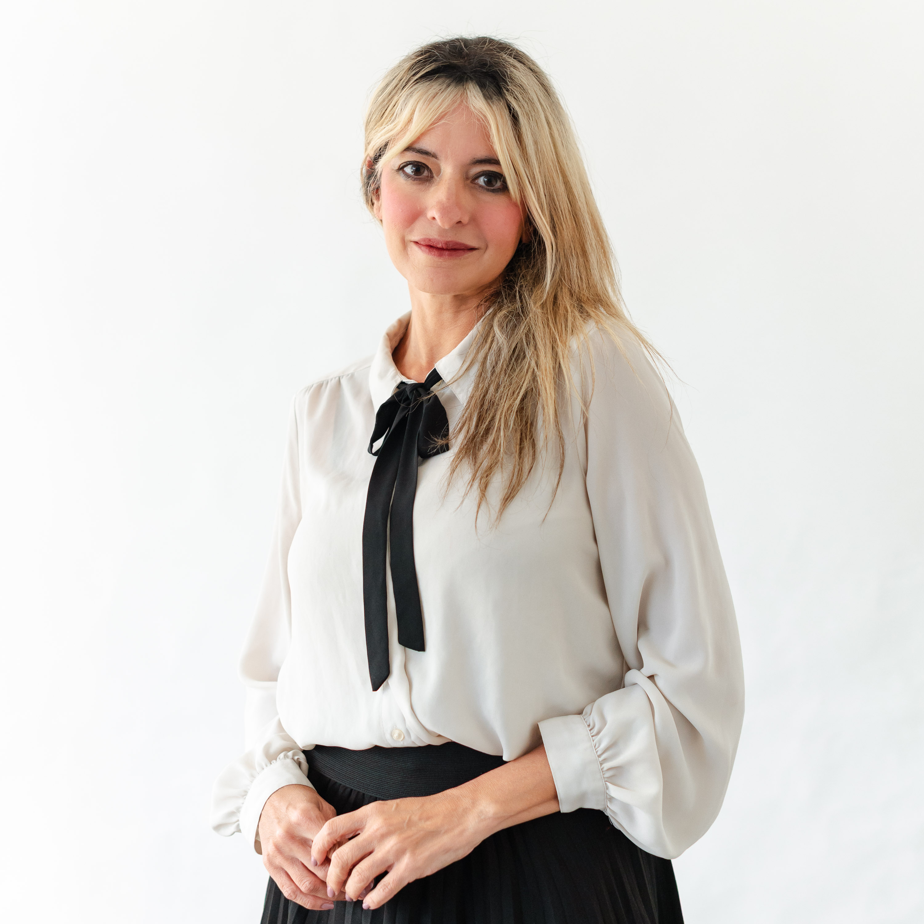 a woman in a white shirt and black skirt