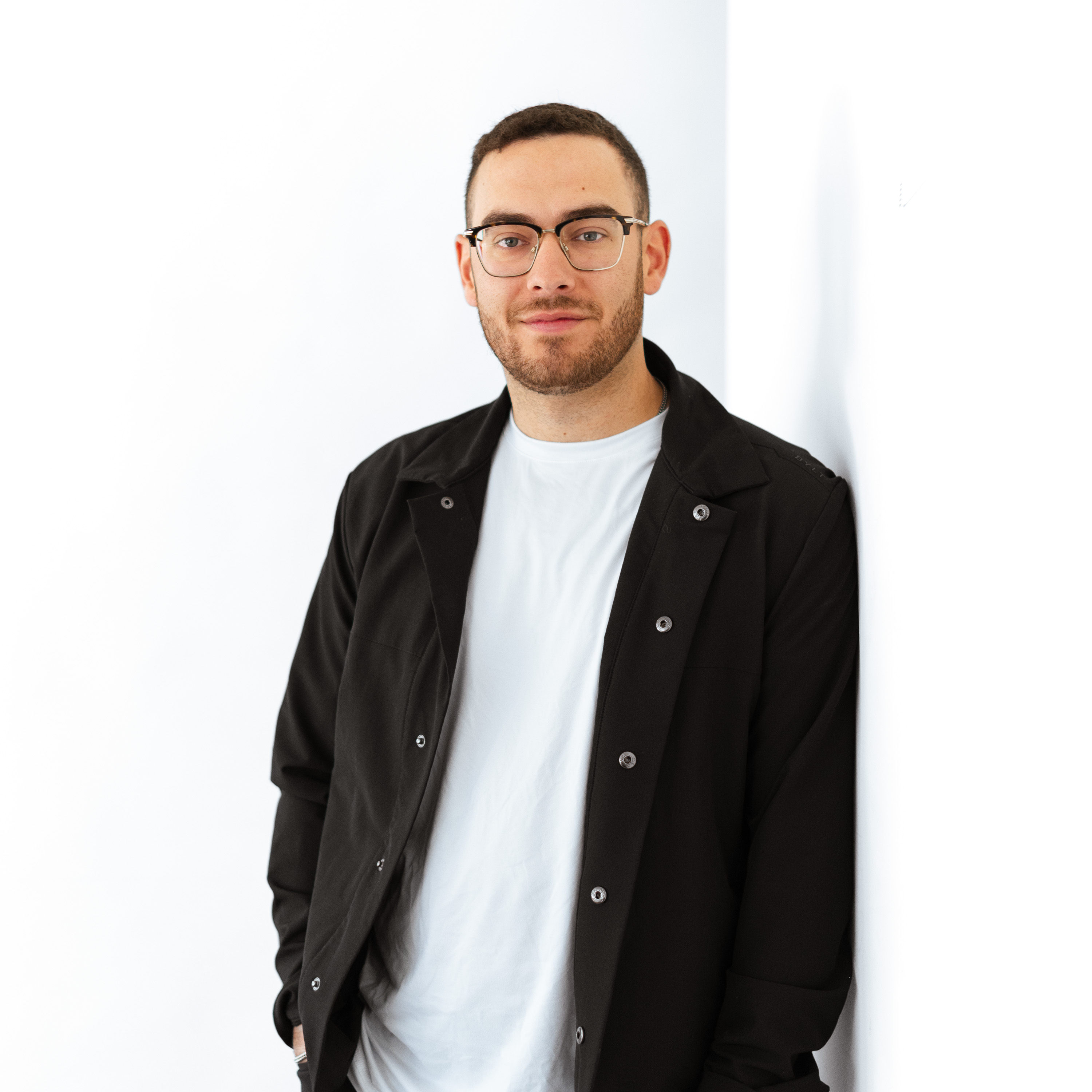 a man leaning against a wall