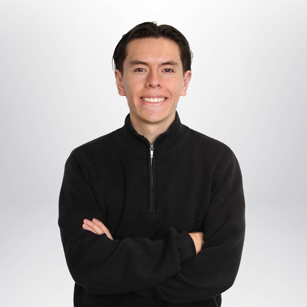 a man smiling with arms crossed