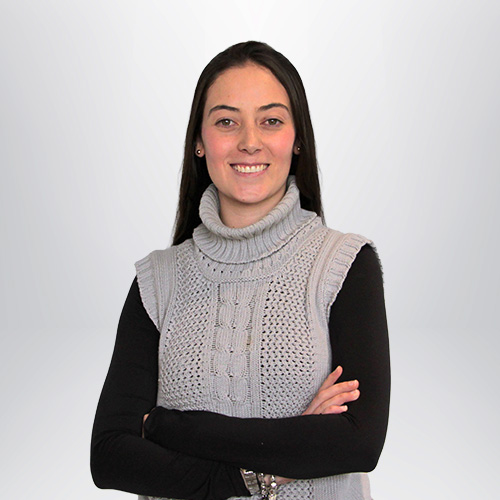 a woman wearing a sweater vest and crossing her arms