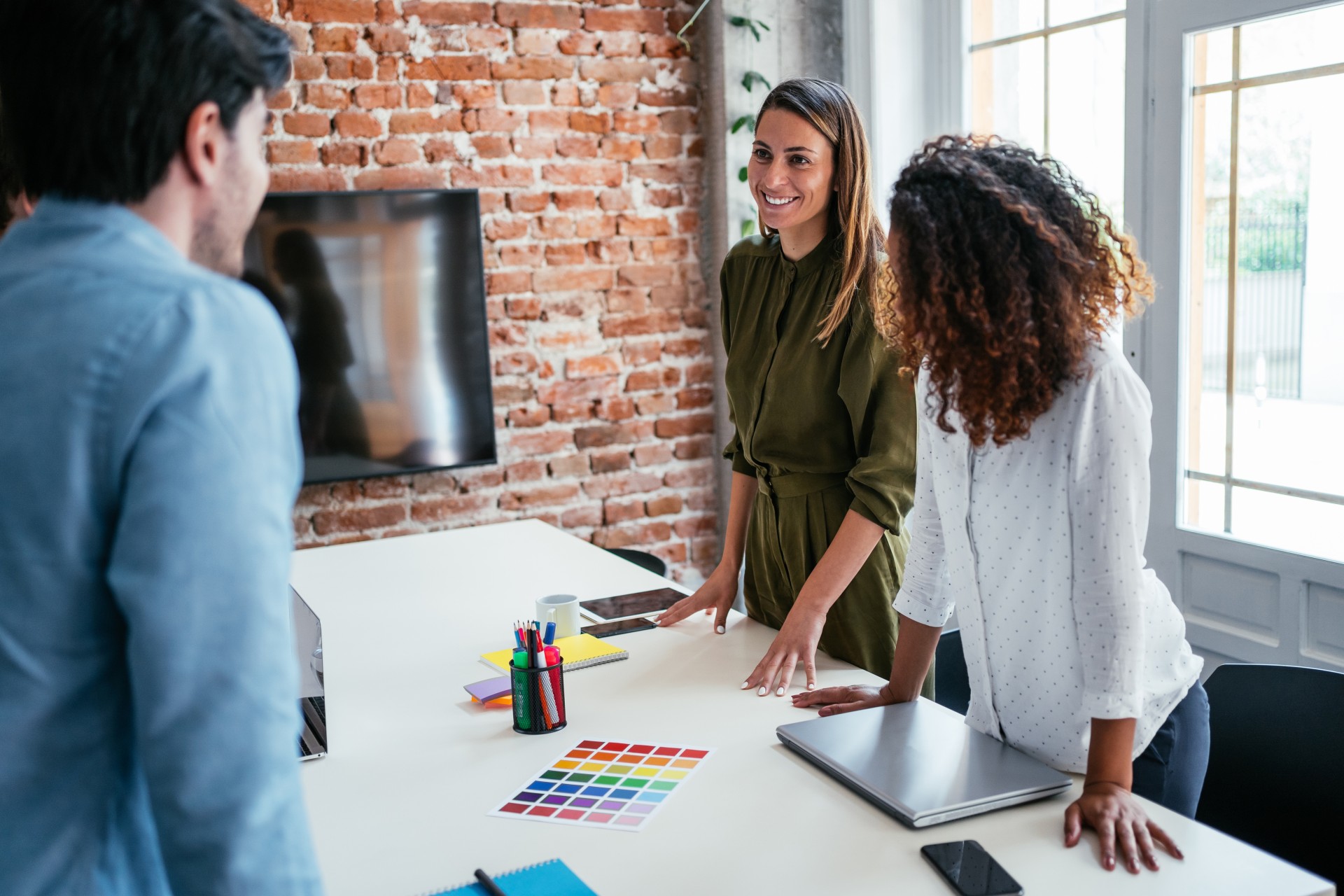a group of people standing around a table
