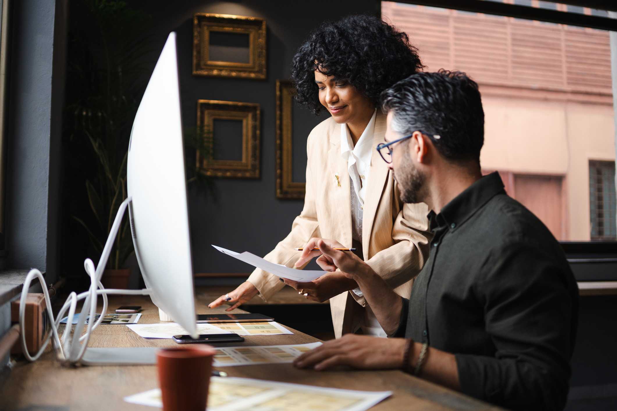a woman and man looking at papers