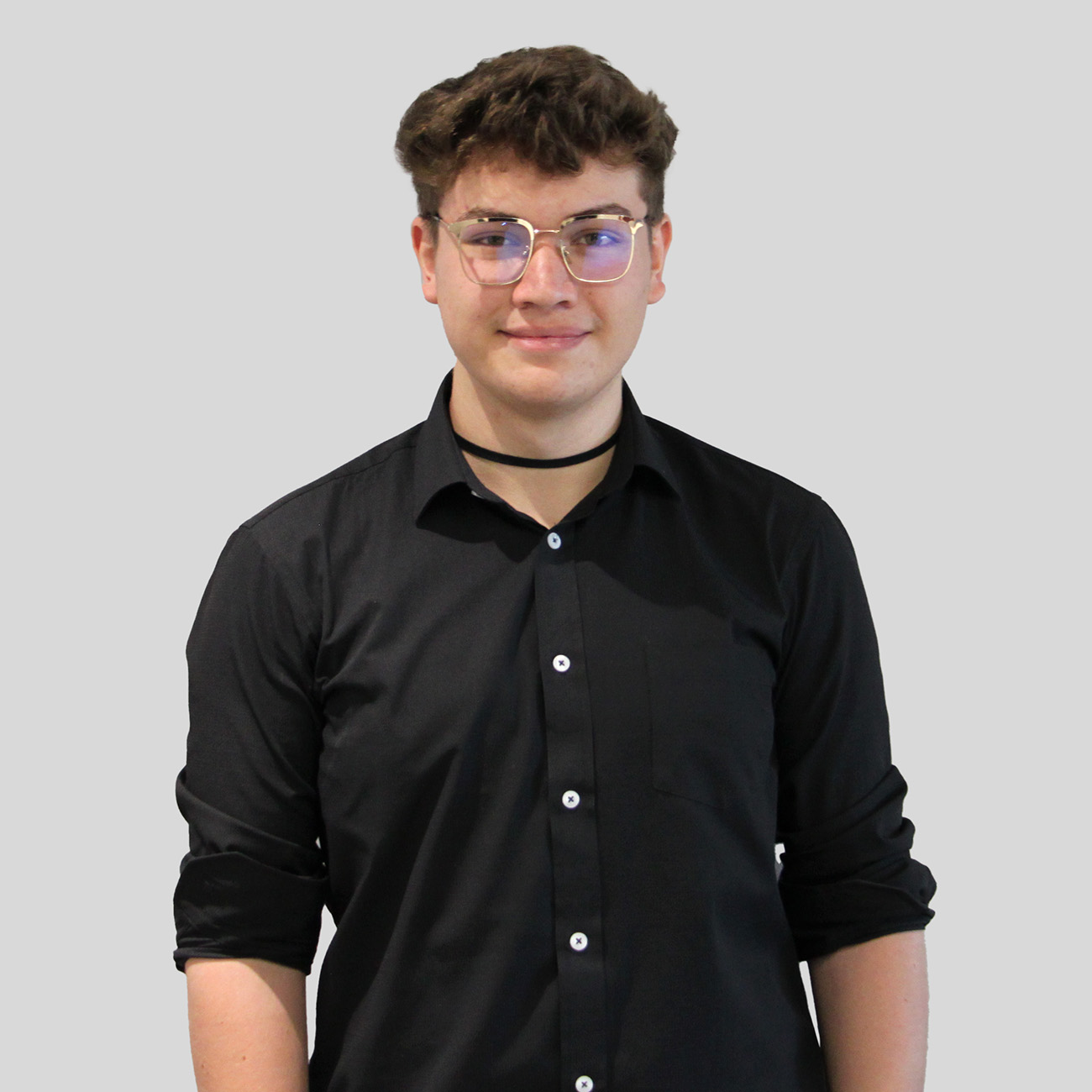 a man wearing glasses and a black shirt