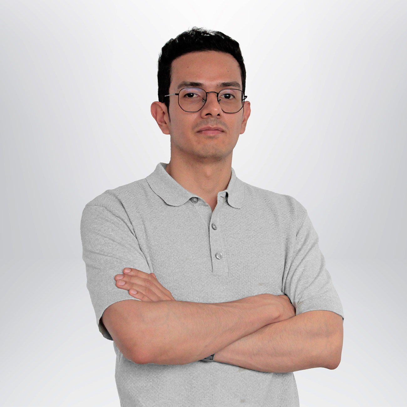 a man with glasses and a grey polo shirt