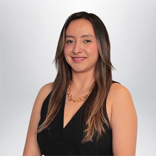 a woman wearing a black vest and a gold necklace