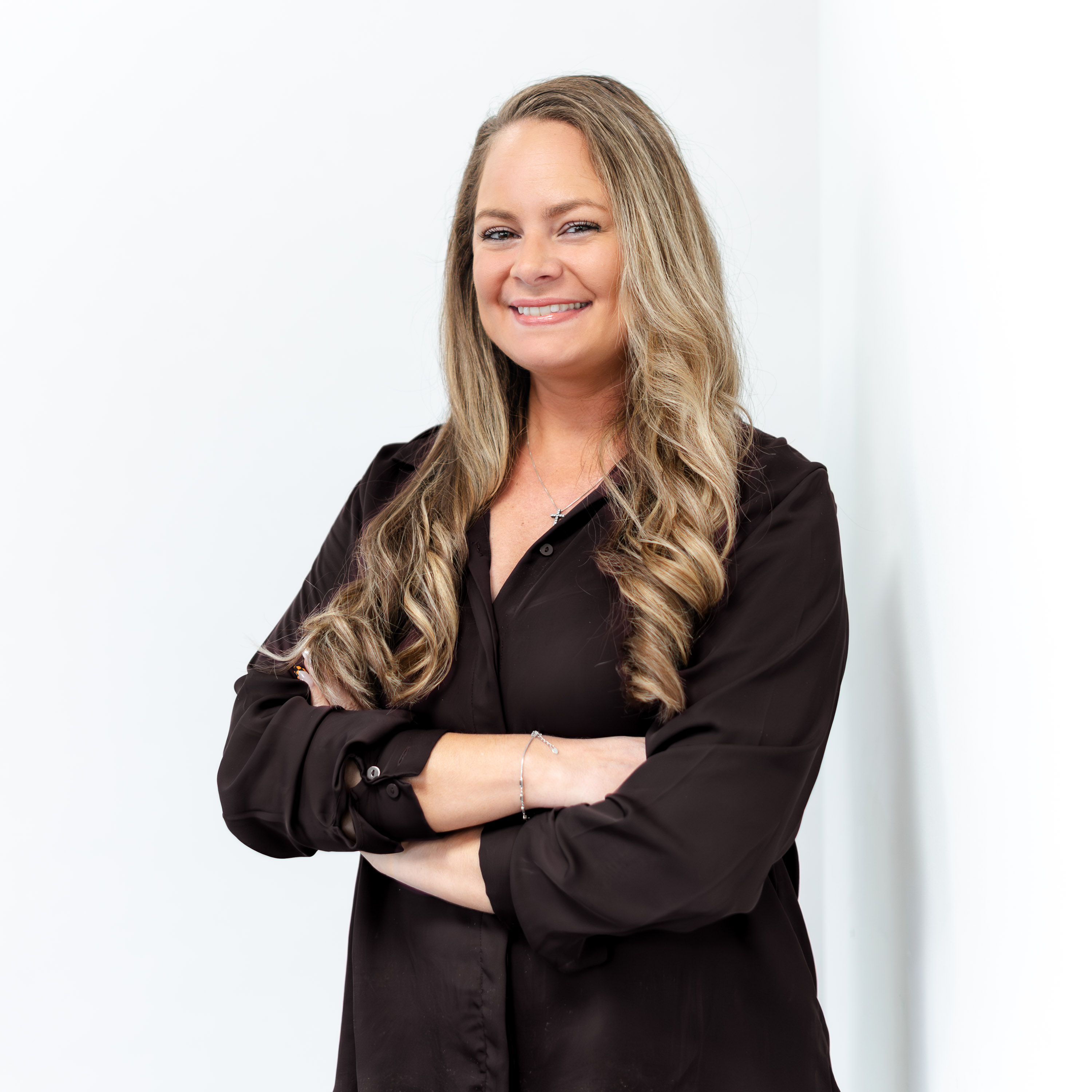 a woman with long blonde hair wearing a black shirt