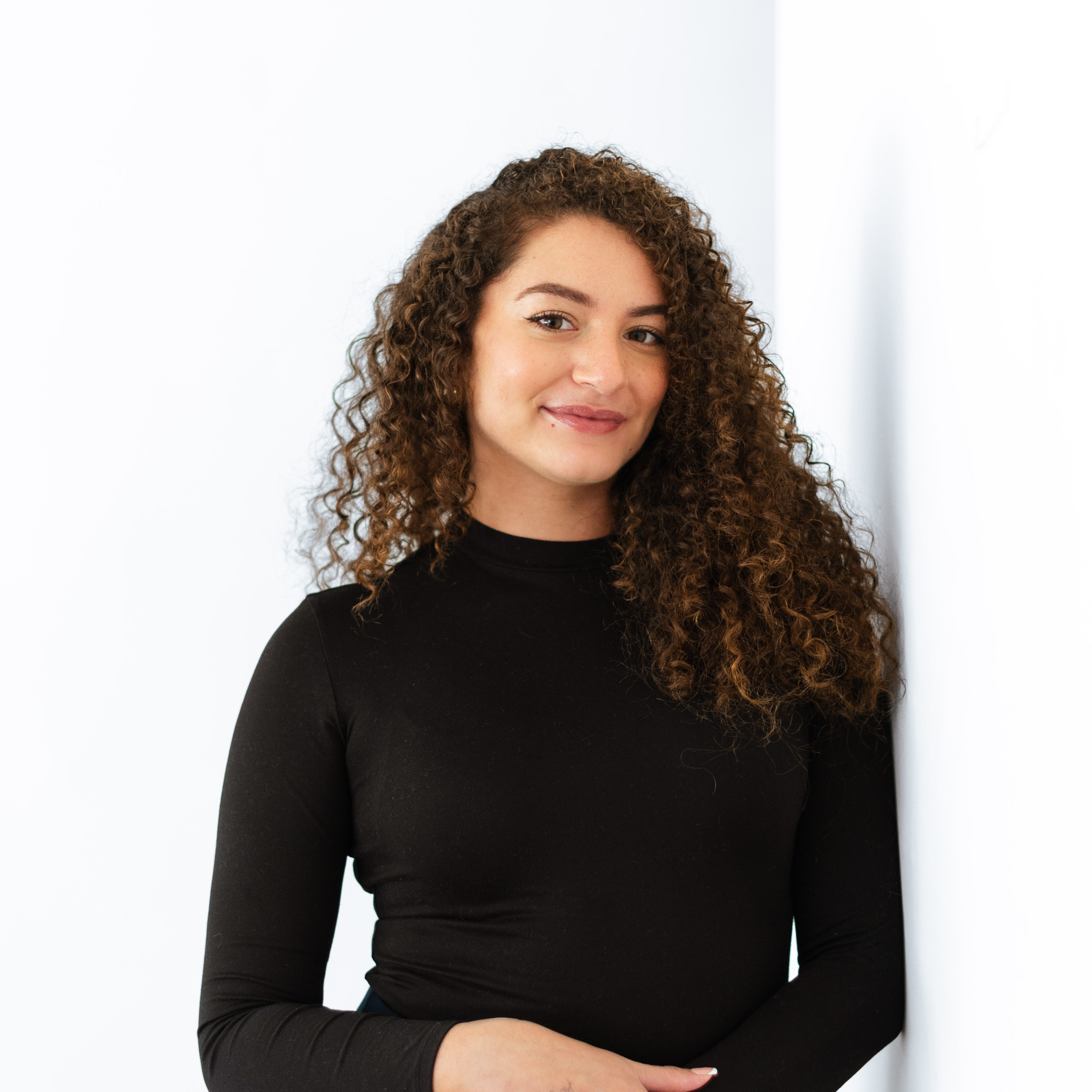 a woman leaning against a wall