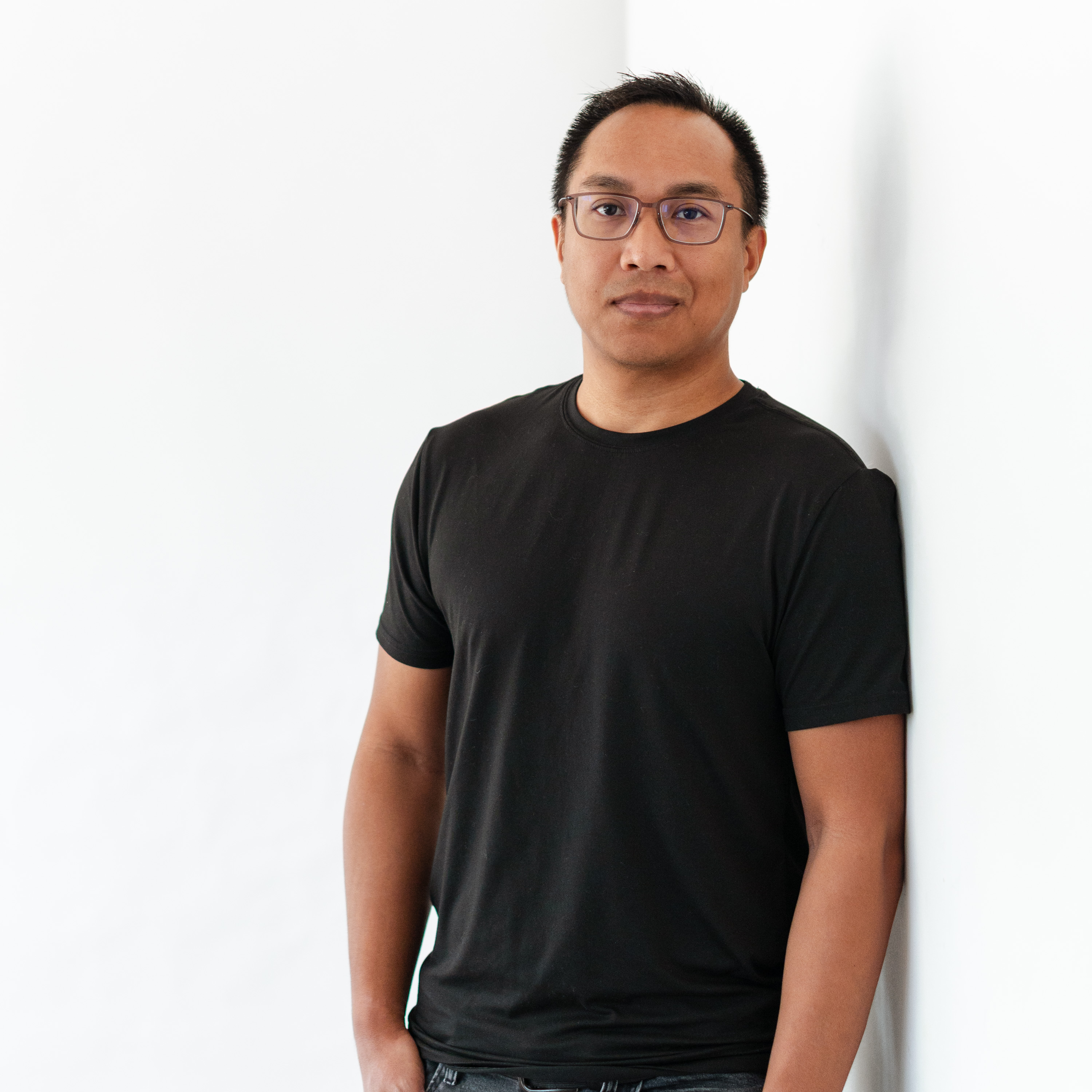 a man leaning against a wall