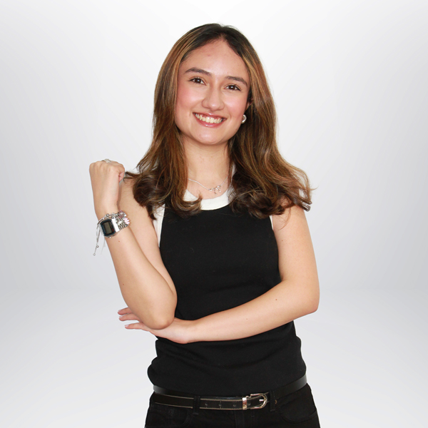a woman smiling with her arms crossed