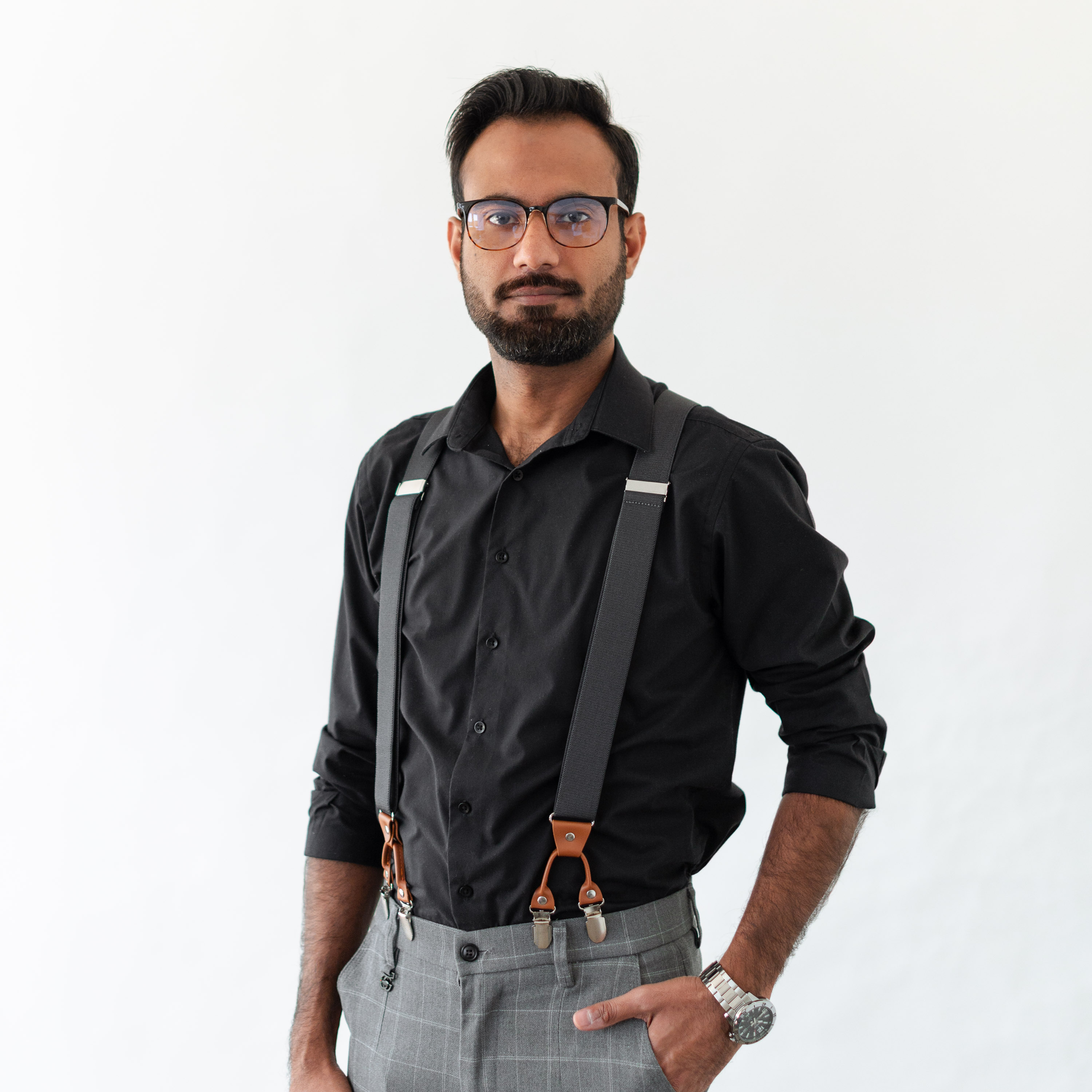 a man wearing suspenders and a black shirt