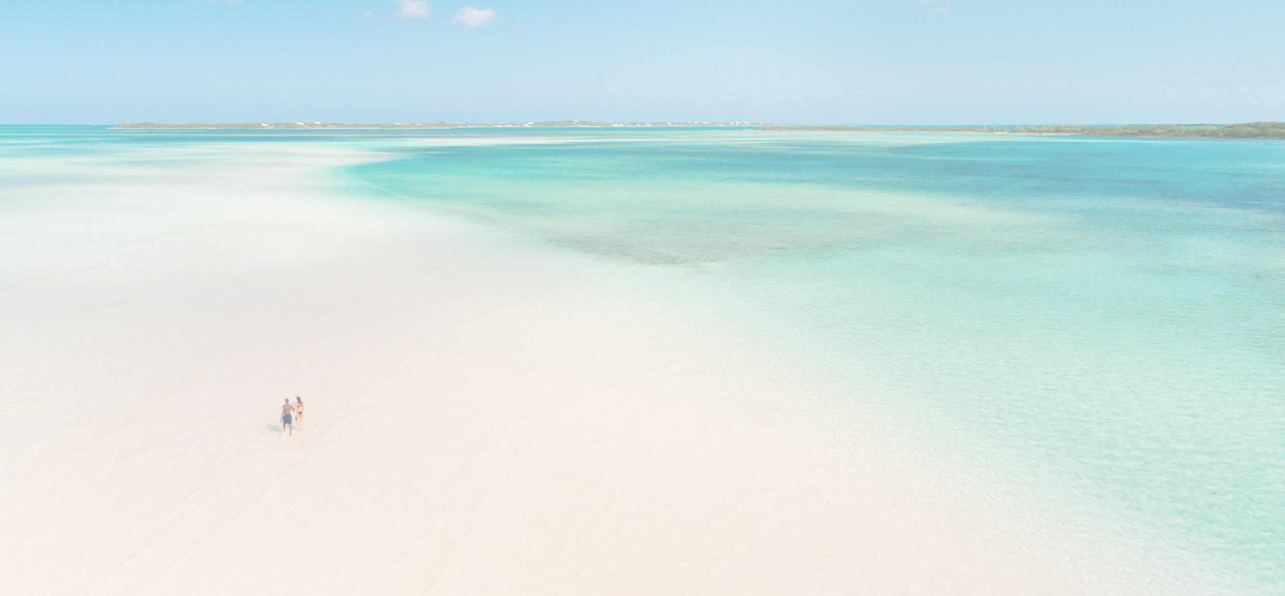 a beach with clear blue water