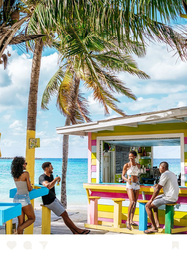 a group of people standing on a beach