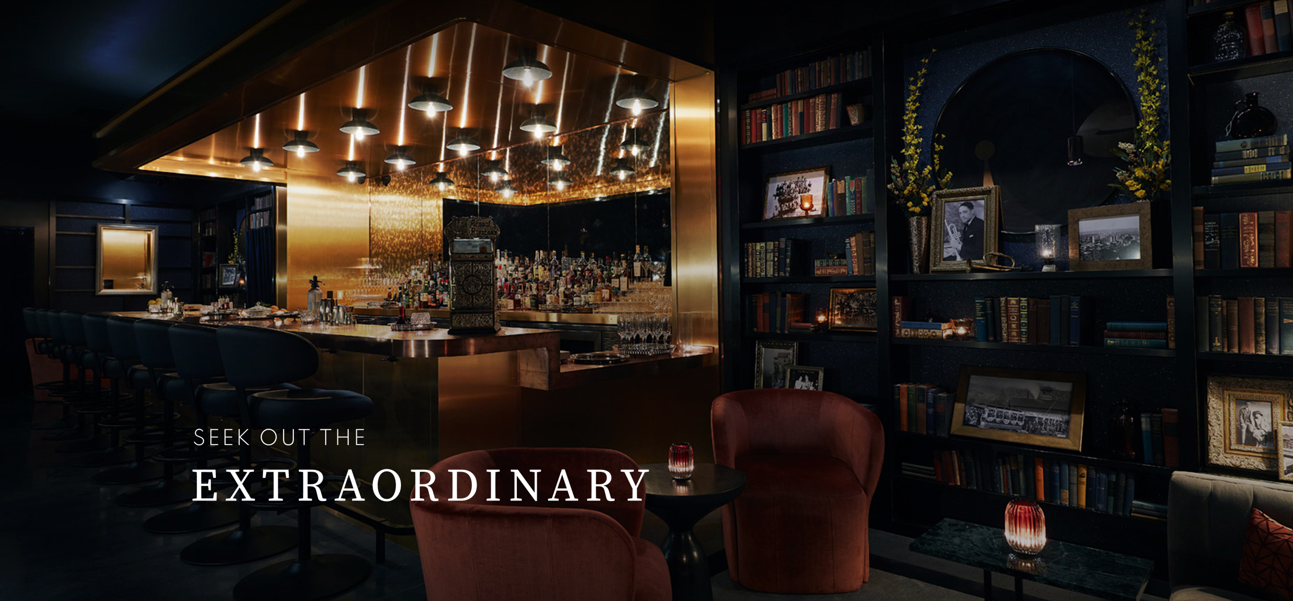 a room with a bar and shelves with books and a mirror