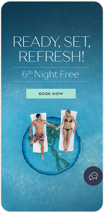 a man and woman lying on floating rafts in a pool