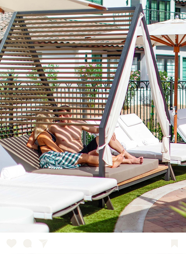 a man and woman sitting on a lounge chair