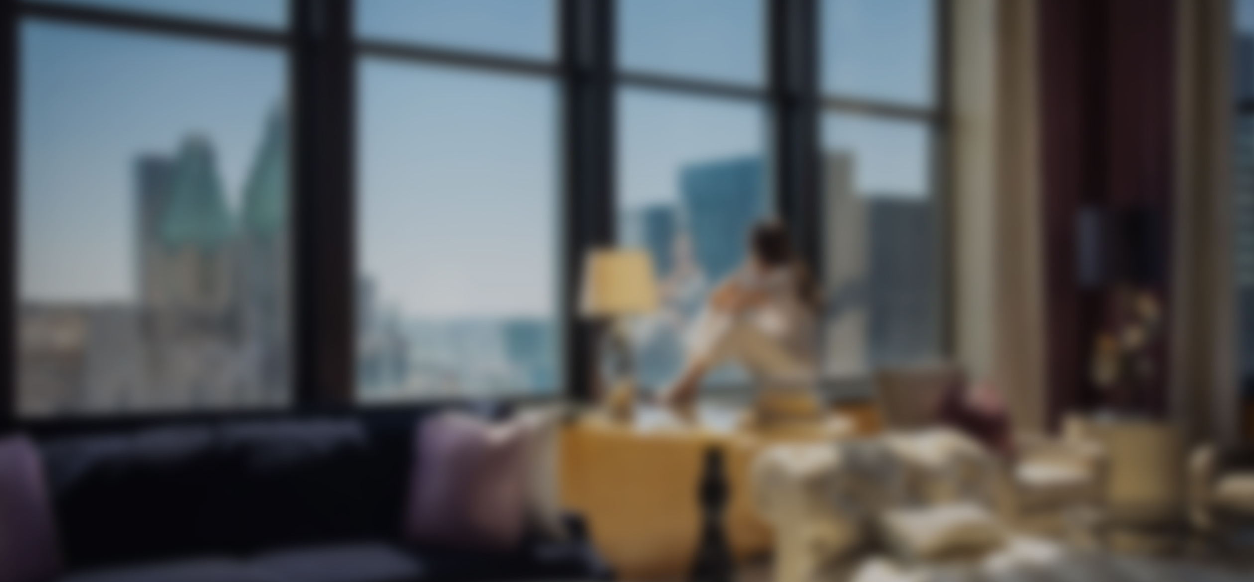 a blurry image of a woman sitting on a couch