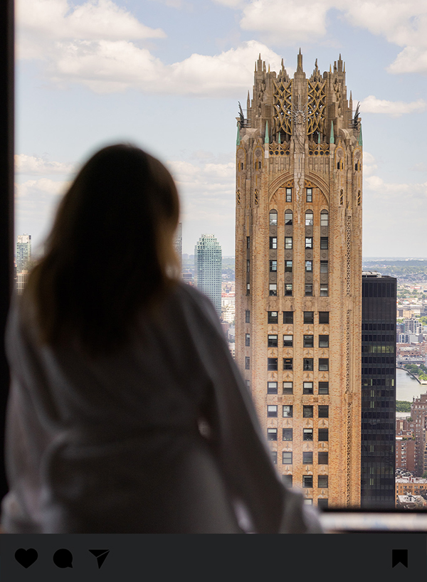a woman looking at a tall building