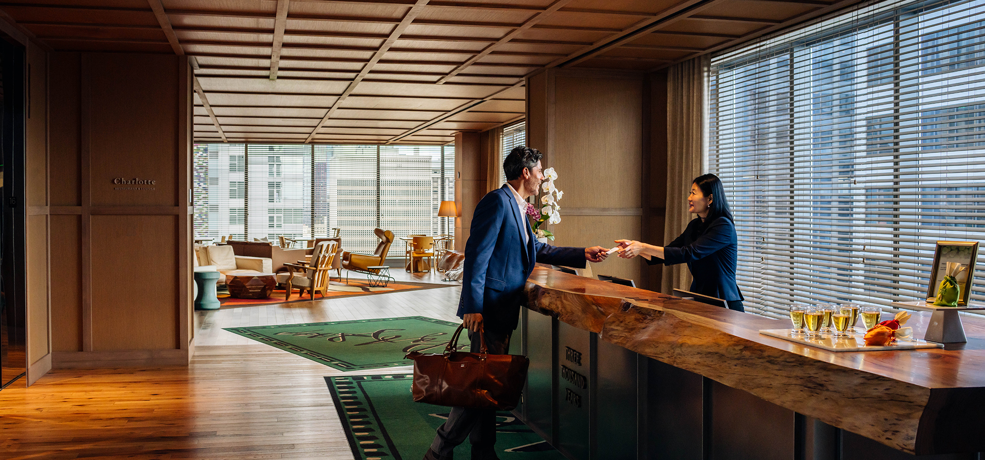 a man and woman shaking hands at a reception desk