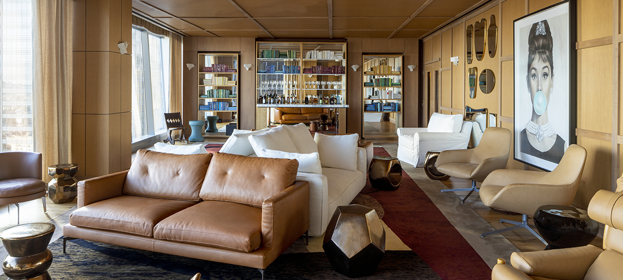 a room with couches and a bookcase