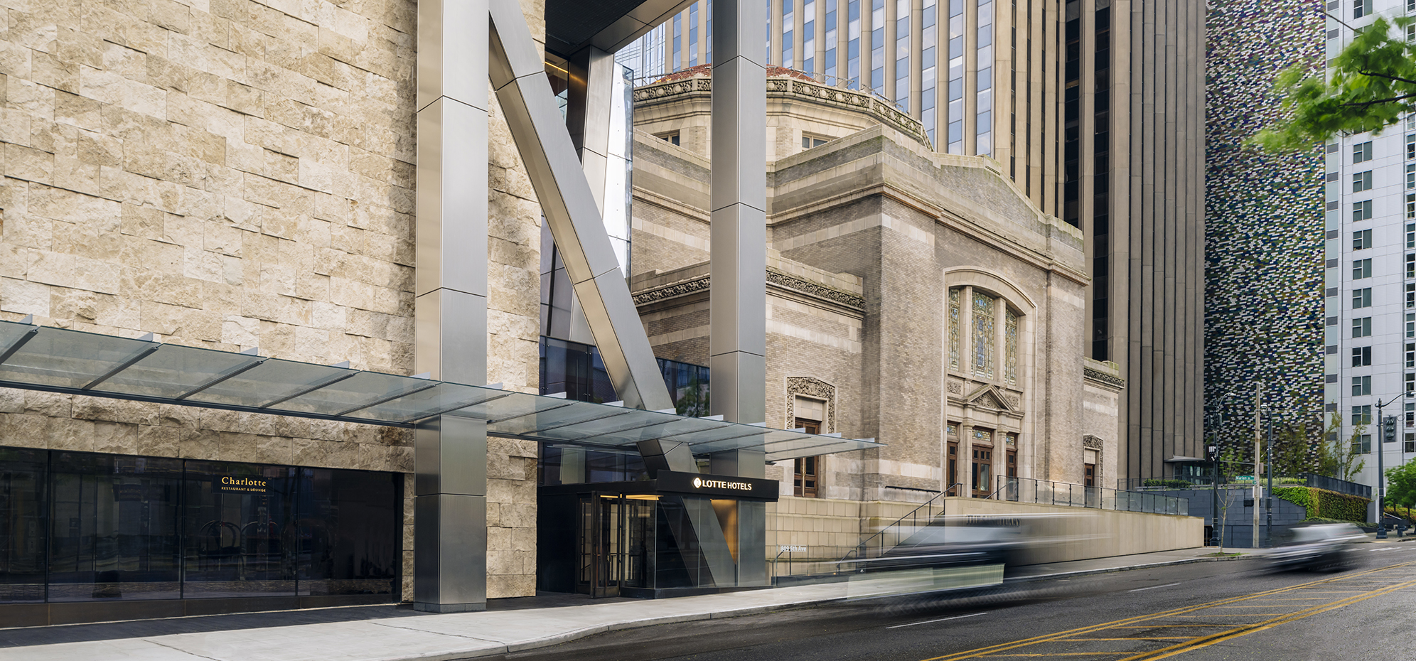 a building with a glass roof and a bus in front of it