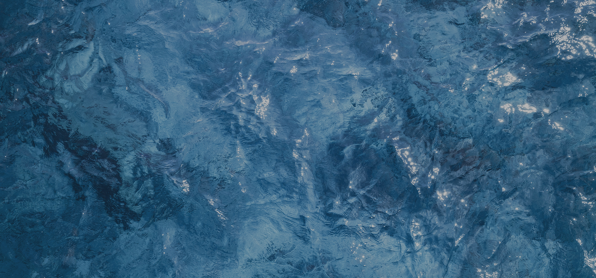 a blue water surface with ripples