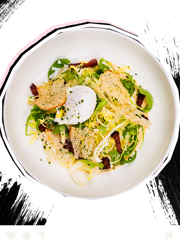 a salad with bacon and croutons