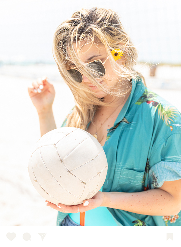 a woman holding a volleyball
