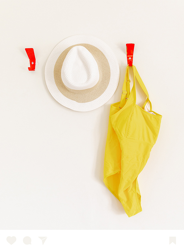 a hat and swimsuit on a wall