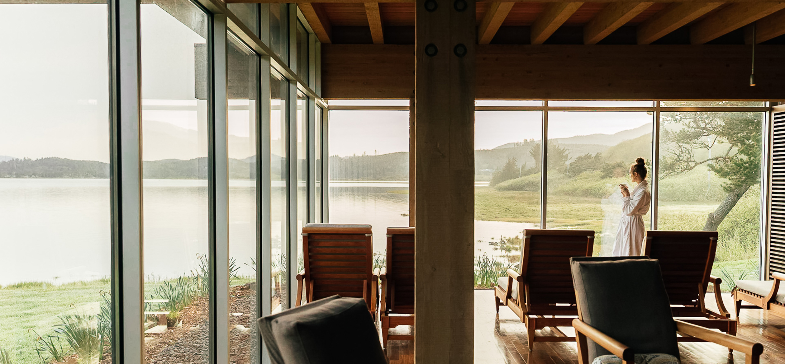 a room with chairs and a lake