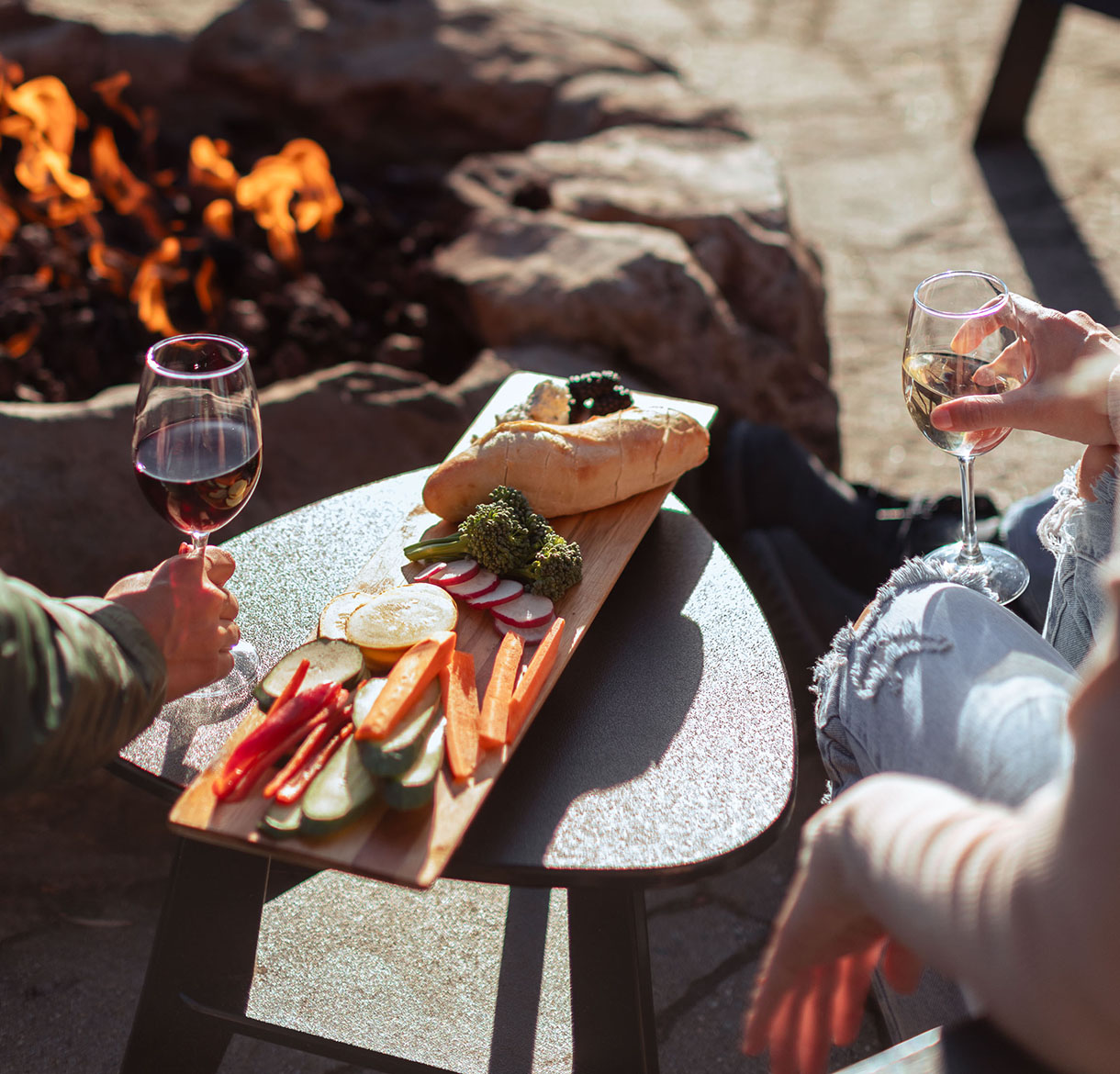 a couple of people sitting at a table with wine and food