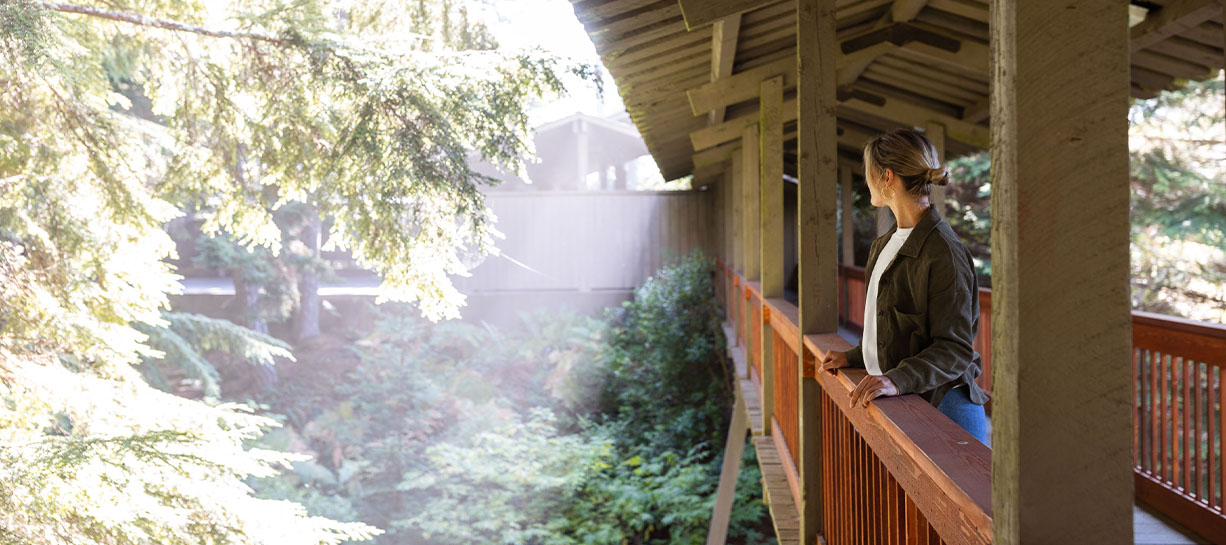 a woman looking out a porch