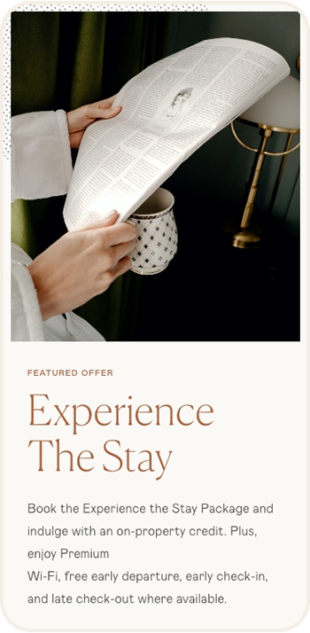 a person holding a book and a cup