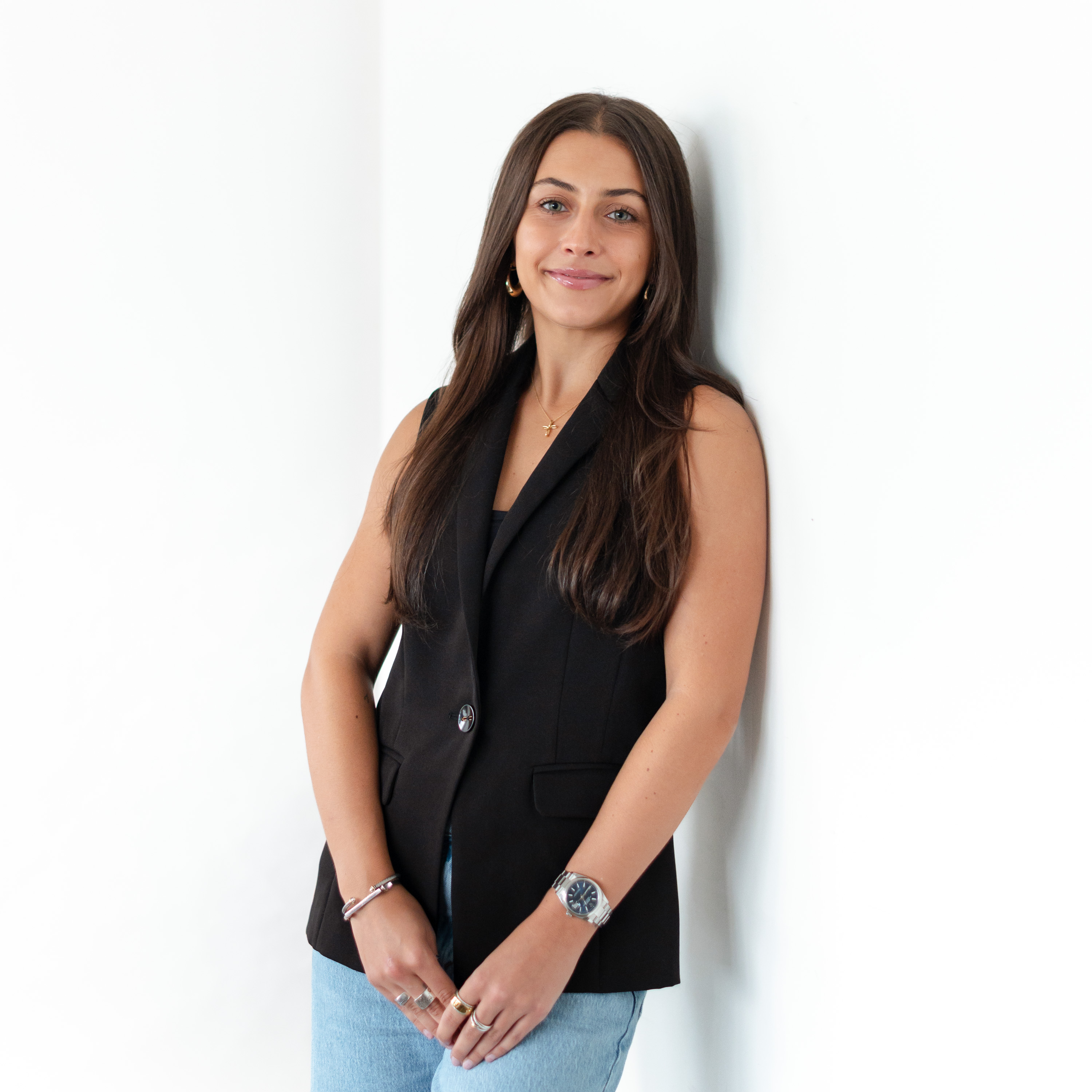 a woman leaning against a wall
