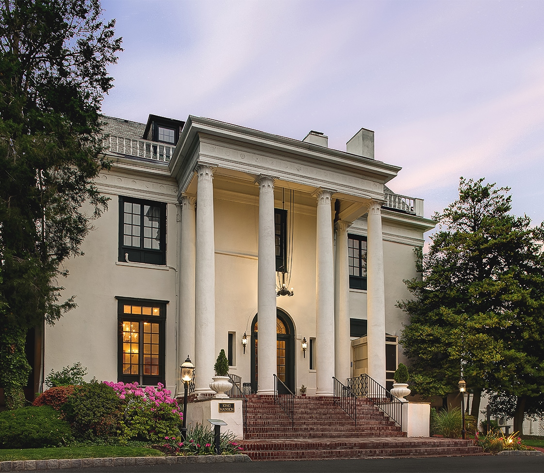 a white house with columns and a staircase