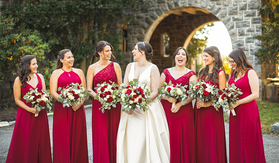 a group of women in red dresses