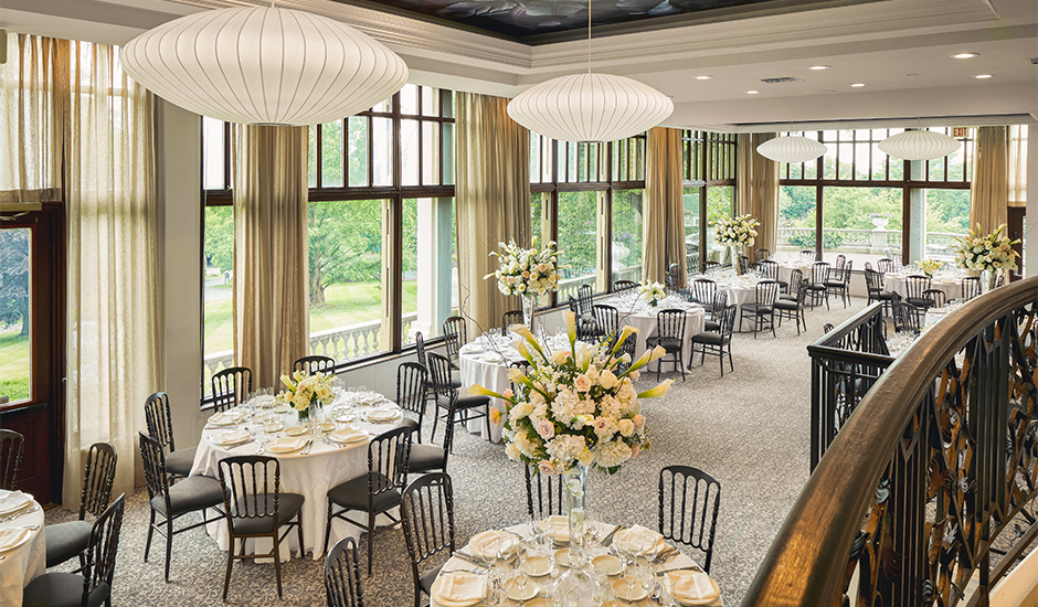 a room with tables and chairs Next