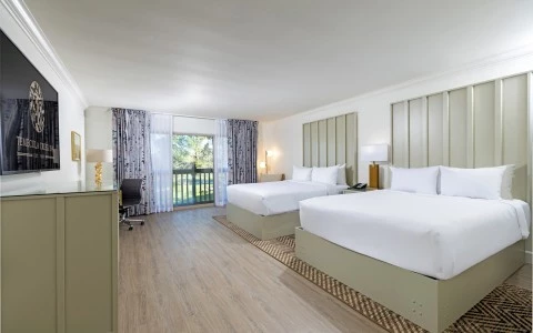 a room with two beds and a desk