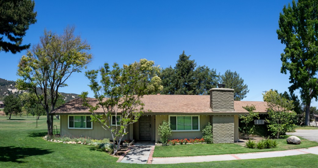 a house with a lawn and trees