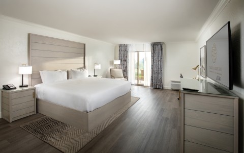 a bedroom with a large bed and a dresser